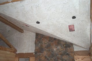 textured ceiling offsets the fireplace