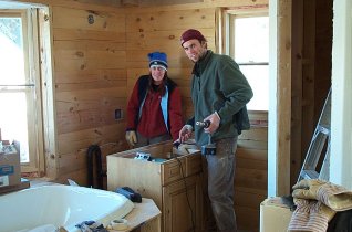 Theresa and Kevin installing a vanity in the Master Bathroom