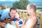 Owen eight weeks old, with Dad and Uncle Kevin